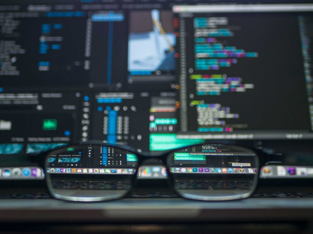 pexels photo 577585 Eyeglasses reflecting computer code on a monitor, ideal for technology and programming themes.